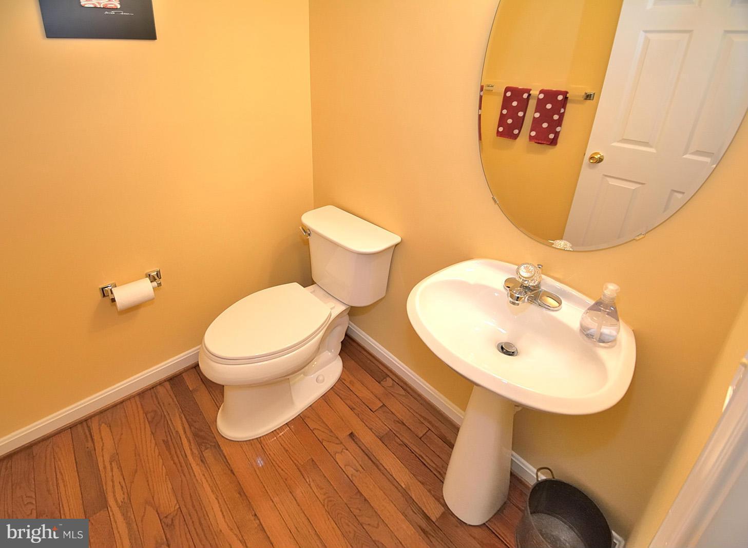 2303 Hurlingham Lane Reston, VA 20191 - Photo 15 of 30 a bathroom with a toilet sink and mirror