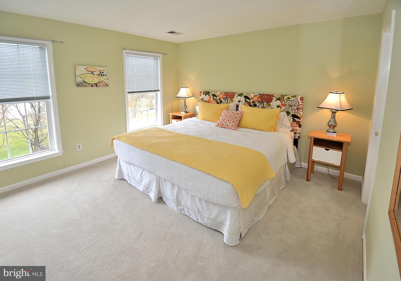 2303 Hurlingham Lane Reston, VA 20191 - Photo 20 of 30 a large bed sitting in a bedroom next to a window