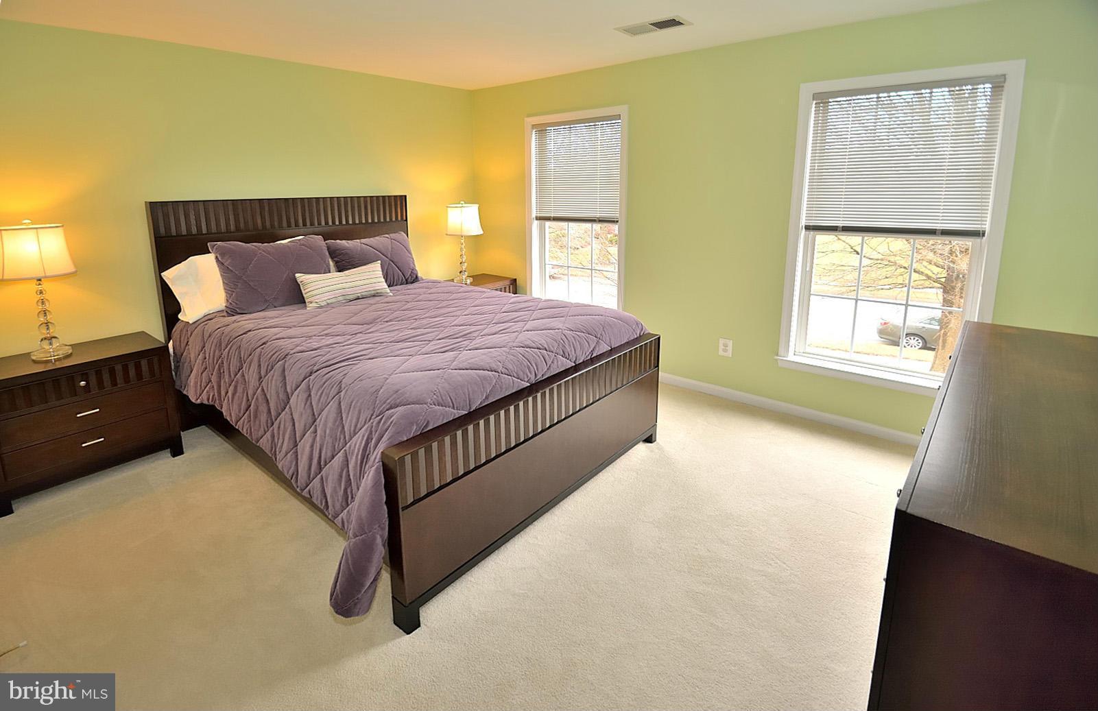 2303 Hurlingham Lane Reston, VA 20191 - Photo 21 of 30 a spacious bedroom with a bed and wooden floor