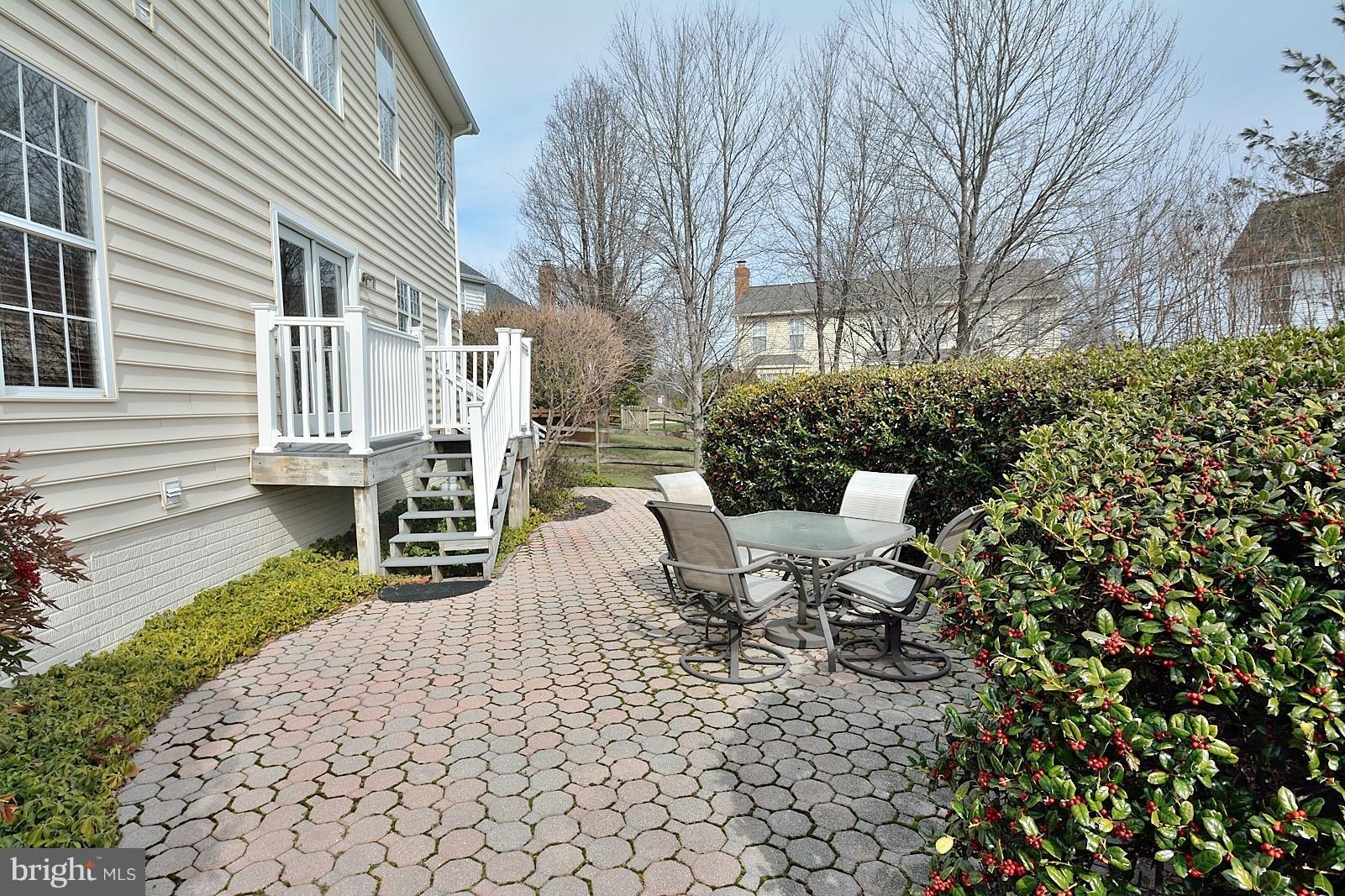 2303 Hurlingham Lane Reston, VA 20191 - Photo 29 of 30 a view of a patio with couches table and chairs and potted plants