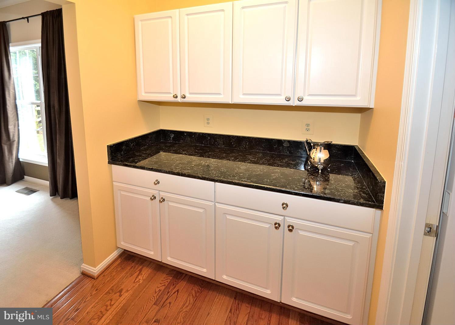 2303 Hurlingham Lane Reston, VA 20191 - Photo 8 of 30 a kitchen with granite countertop white cabinets and sink