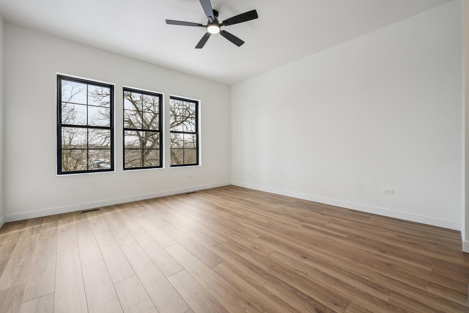 298 Apache Trail Lake In The Hills, IL 60156 - Photo 11 of 23 a view of an empty room with wooden floor and a window