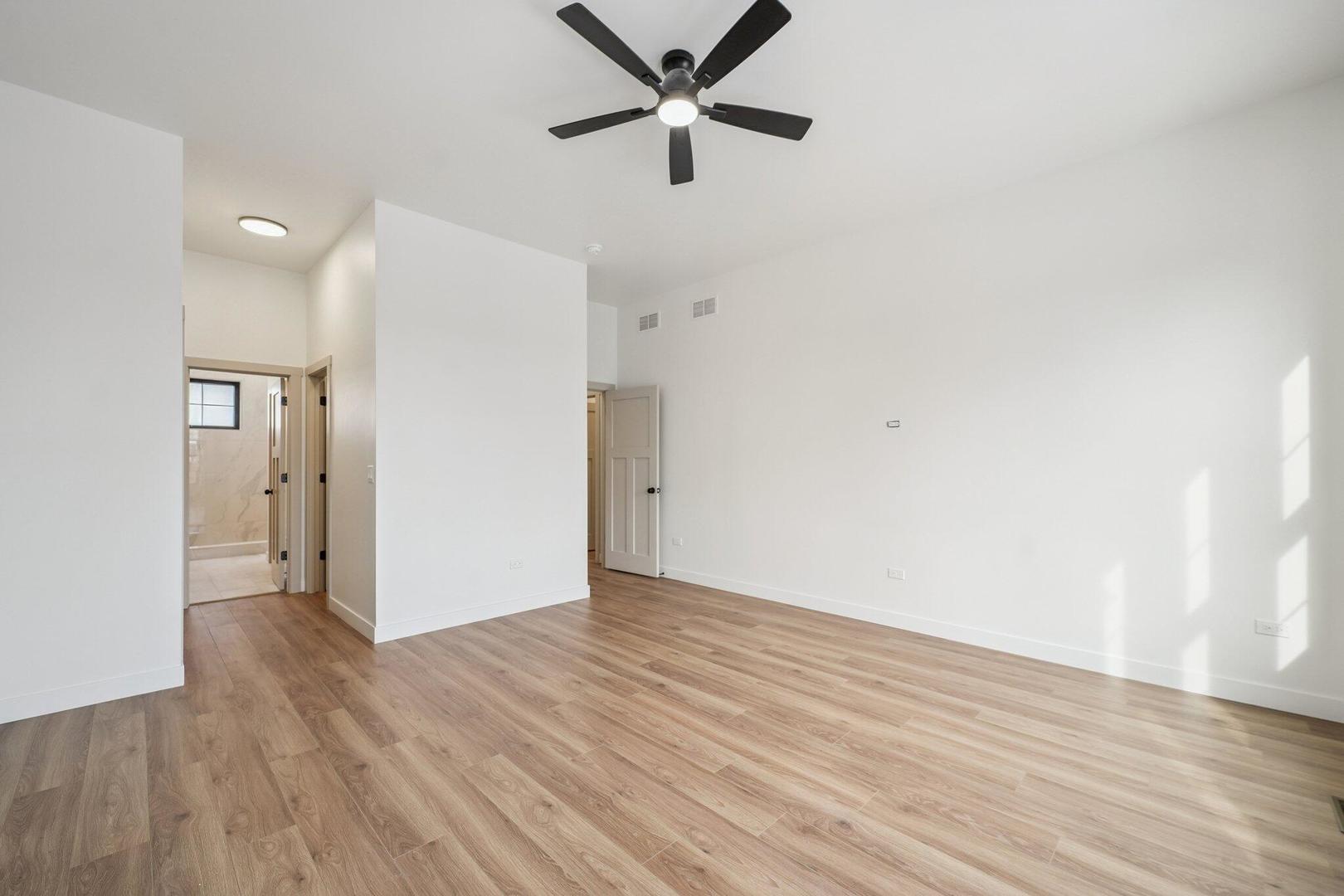 298 Apache Trail Lake In The Hills, IL 60156 - Photo 12 of 23 an empty room with wooden floor a ceiling fan and closet