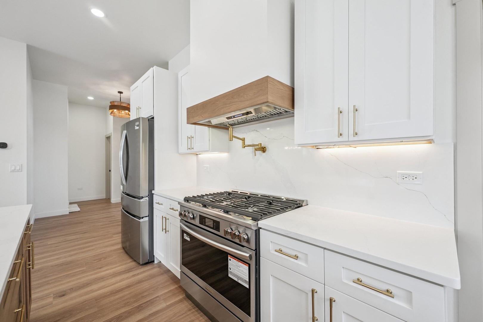 298 Apache Trail Lake In The Hills, IL 60156 - Photo 16 of 23 a kitchen with stainless steel appliances white cabinets and a stove