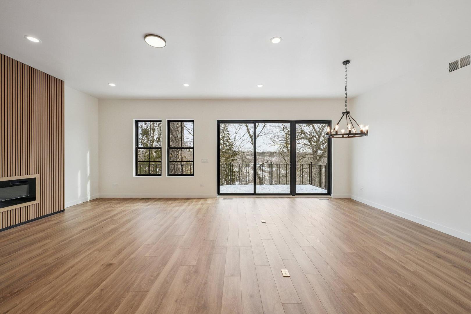 298 Apache Trail Lake In The Hills, IL 60156 - Photo 6 of 23 a view of an empty room with wooden floor and a window
