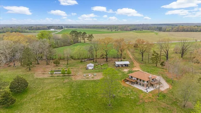a white house with a yard and sitting area