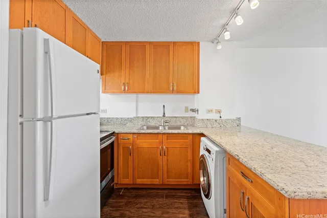 a bathroom with a granite countertop sink and a shower