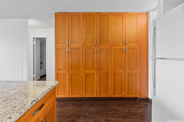 a bathroom with a granite countertop toilet sink and mirror