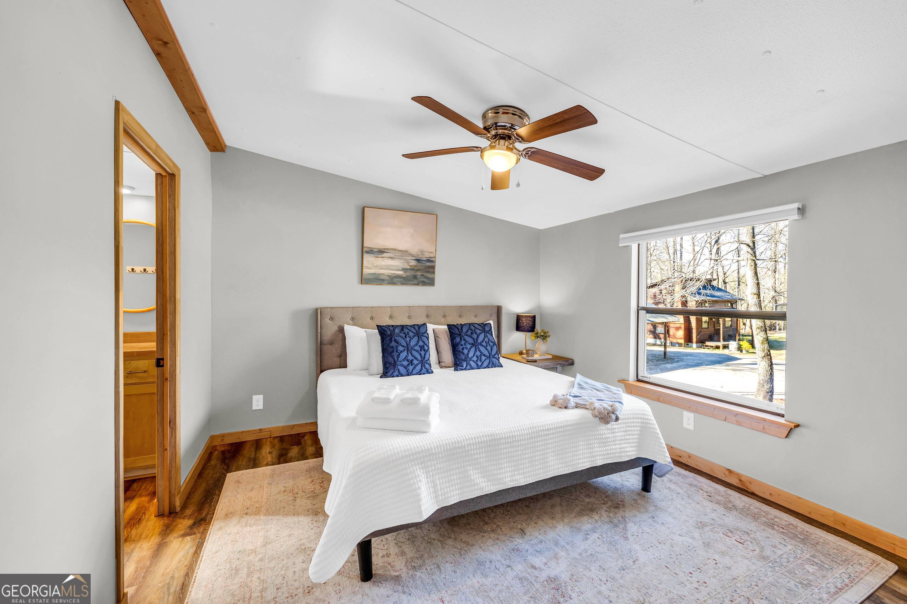 284 Duncan Bridge Road Sautee Nacoochee, GA 30571 - Photo 17 of 69 a bedroom with a bed a window and a chandelier