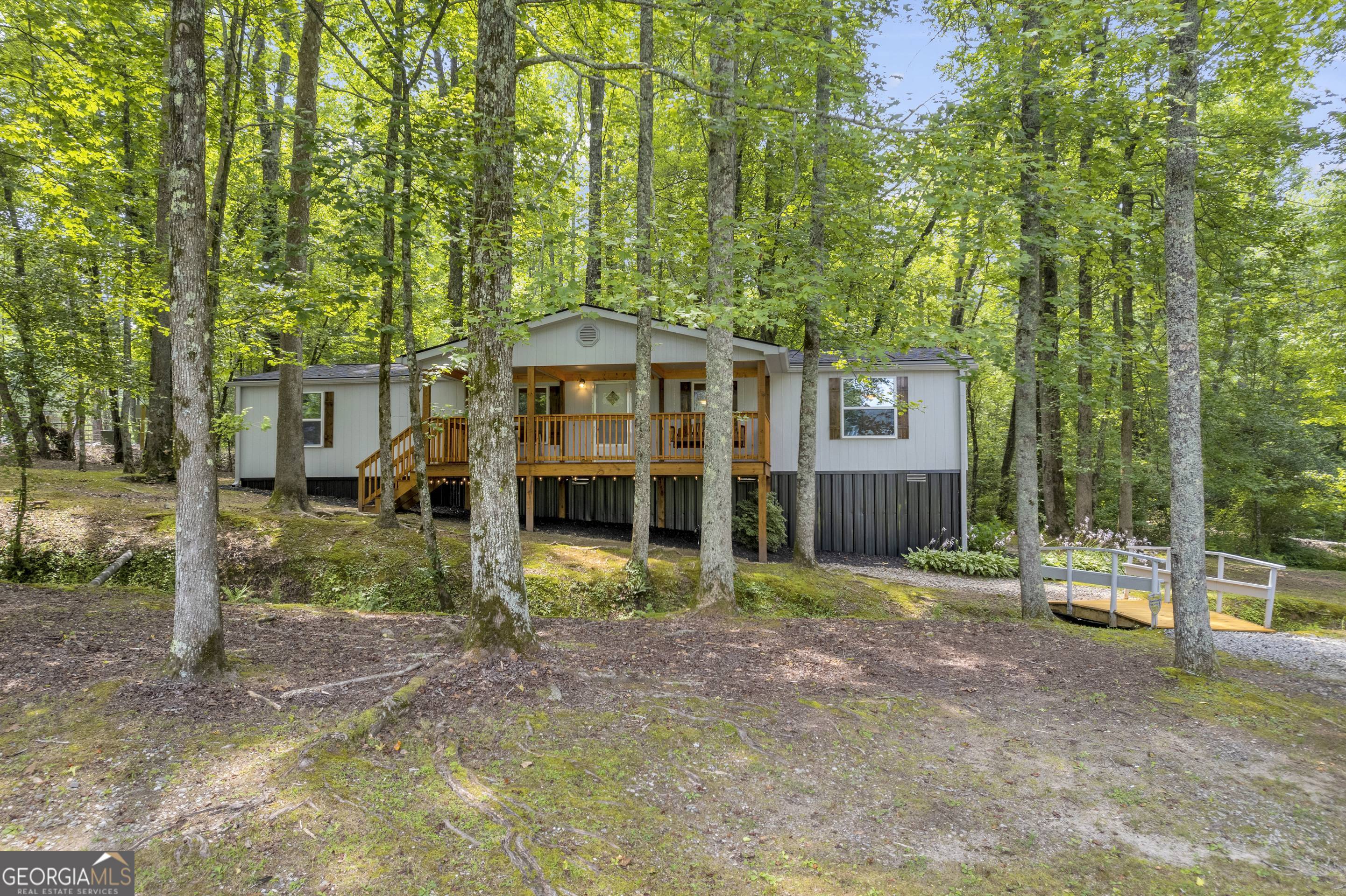 284 Duncan Bridge Road Sautee Nacoochee, GA 30571 - Photo 5 of 69 a view of a big house with large trees and plants