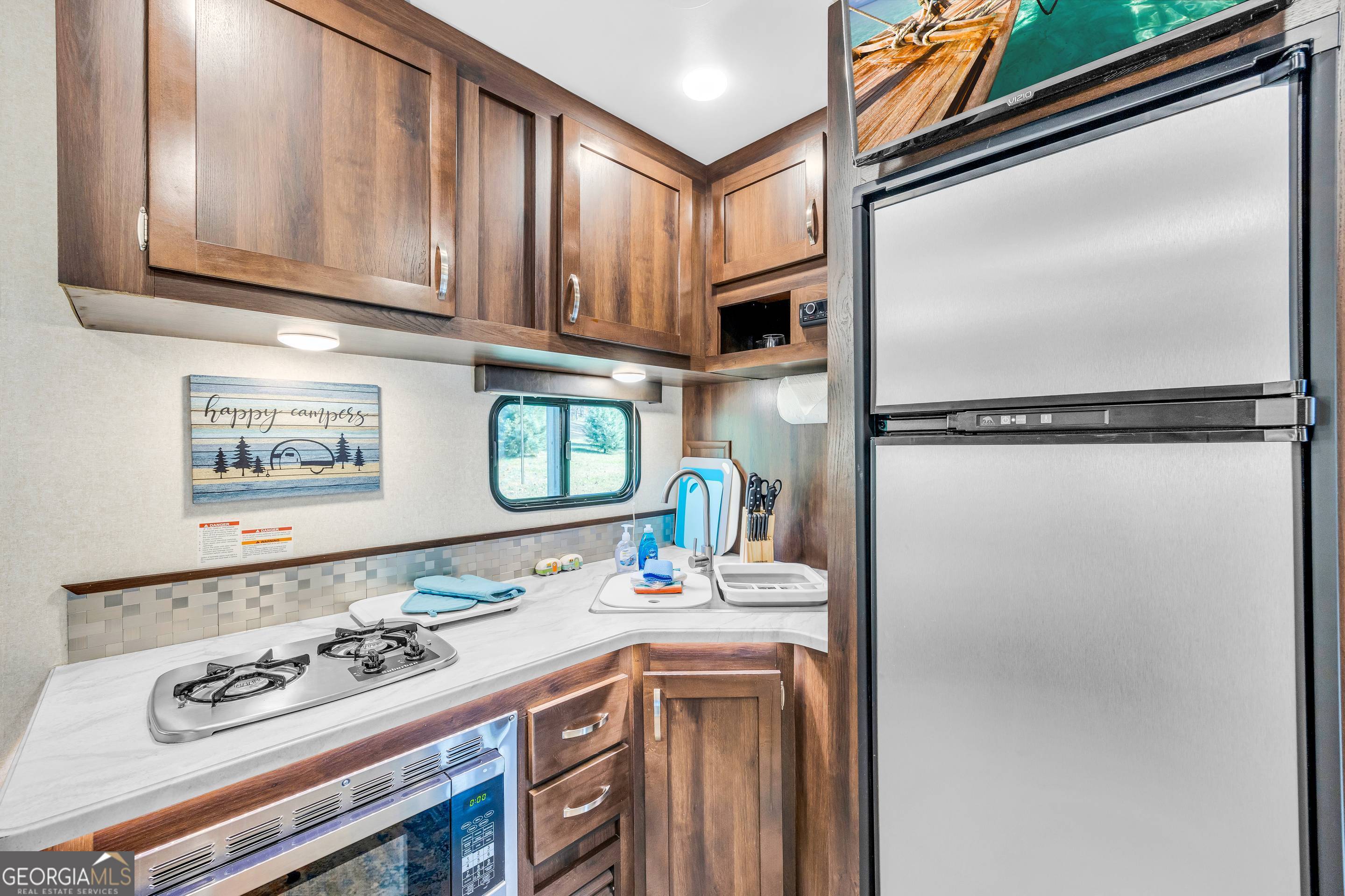 284 Duncan Bridge Road Sautee Nacoochee, GA 30571 - Photo 63 of 69 a kitchen with stainless steel appliances granite countertop a sink stove and refrigerator