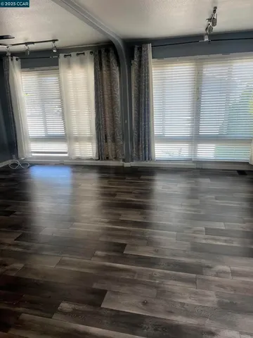 a view of wooden floor and windows in a room