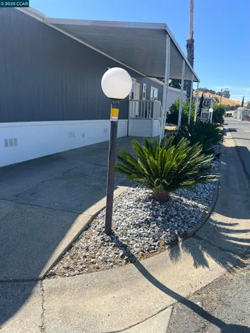 a view of a house with a backyard and sitting area