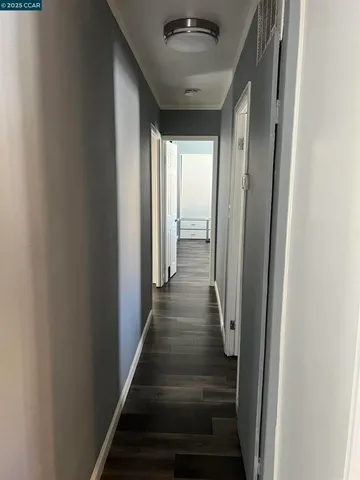 a view of a hallway with the wooden floor