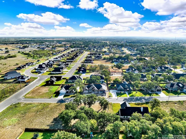 an aerial view of residential houses with outdoor space