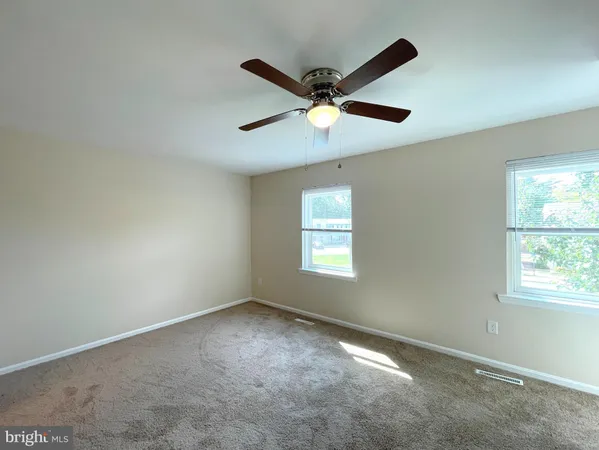 a view of empty room with a ceiling fan