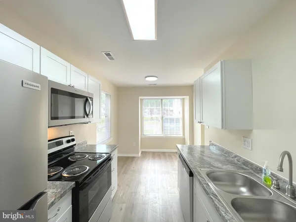 a kitchen with granite countertop a stove and a sink