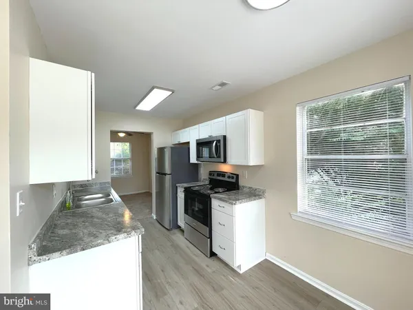 a kitchen with stainless steel appliances granite countertop a stove and a sink