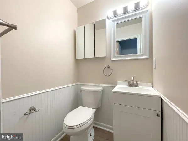 a bathroom with a toilet a sink and mirror