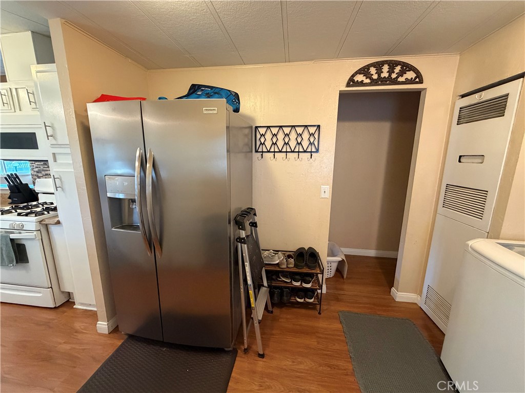 1550 Rimpau Avenue, Unit 138 Corona, CA 92881 - Photo 11 of 29 a view of a refrigerator in kitchen and an empty room