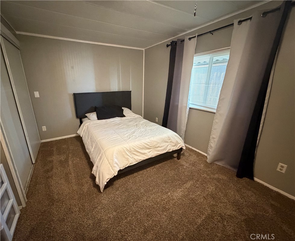 1550 Rimpau Avenue, Unit 138 Corona, CA 92881 - Photo 13 of 29 a bed sitting in a room next to a window