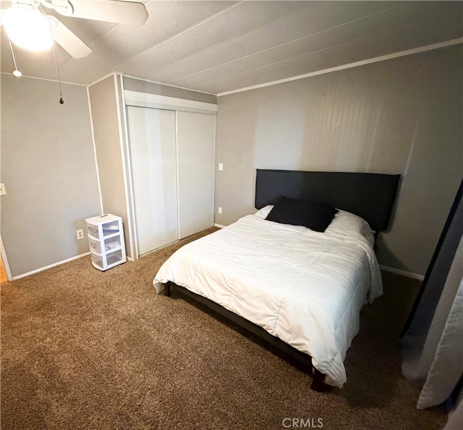 1550 Rimpau Avenue, Unit 138 Corona, CA 92881 - Photo 15 of 29 a large bed sitting in a room next to a window