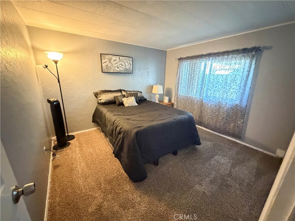 1550 Rimpau Avenue, Unit 138 Corona, CA 92881 - Photo 16 of 29 a bedroom with a bed and a window