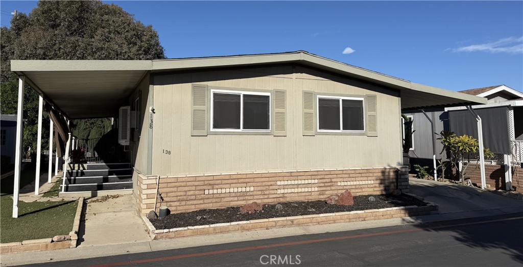 1550 Rimpau Avenue, Unit 138 Corona, CA 92881 - Photo 25 of 29 a front view of a house with a garage