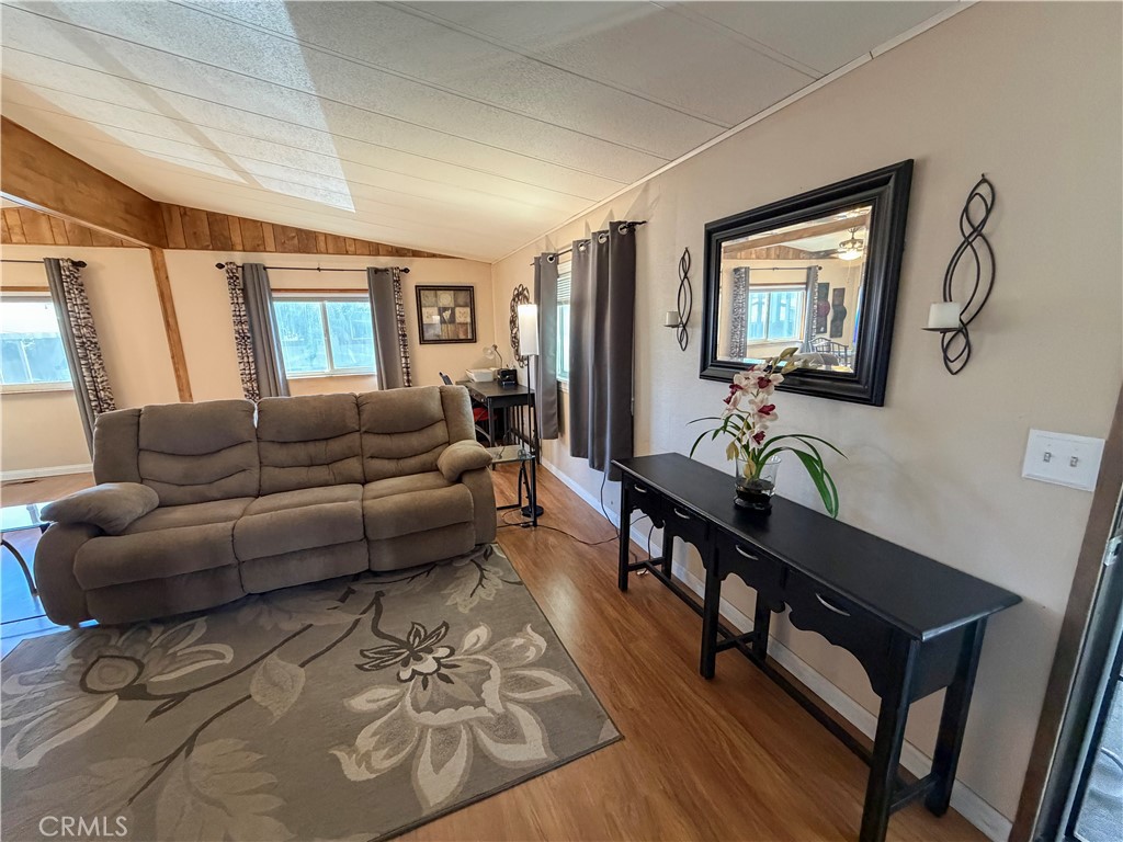 1550 Rimpau Avenue, Unit 138 Corona, CA 92881 - Photo 3 of 29 a living room with furniture a desk and chair with wooden floor