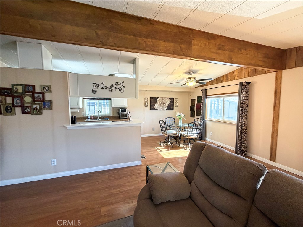 1550 Rimpau Avenue, Unit 138 Corona, CA 92881 - Photo 4 of 29 a living room with furniture and wooden floor