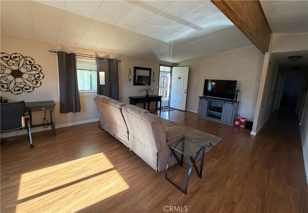 1550 Rimpau Avenue, Unit 138 Corona, CA 92881 - Photo 5 of 29 a living room with furniture and a flat screen tv
