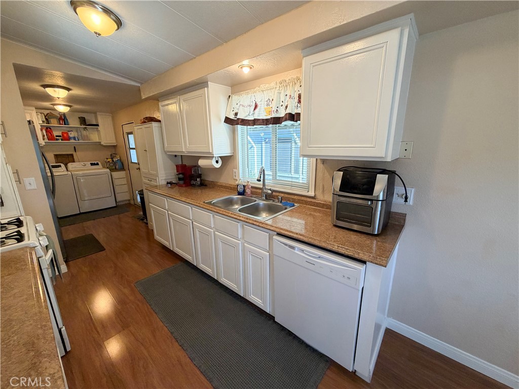 1550 Rimpau Avenue, Unit 138 Corona, CA 92881 - Photo 9 of 29 a kitchen with stainless steel appliances granite countertop a sink stove and cabinets