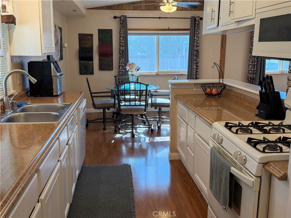 1550 Rimpau Avenue, Unit 138 Corona, CA 92881 - Photo 10 of 29 a kitchen with a sink stove and cabinets