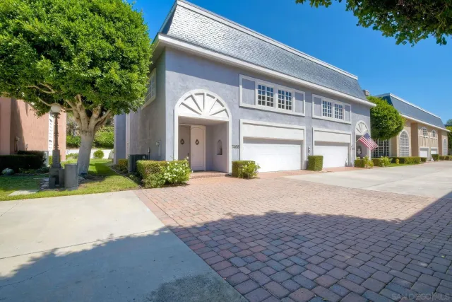 a front view of a house with a yard and a garage