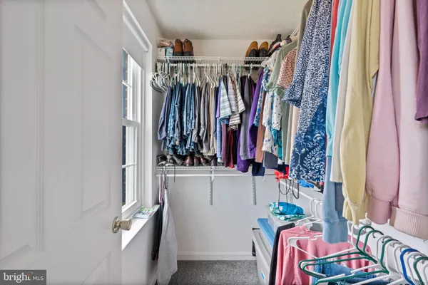 a view of an empty room with a fan