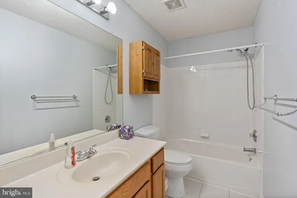 a bathroom with a sink vanity and mirror