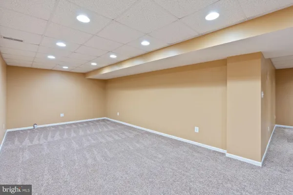 an empty room with a empty space and windows