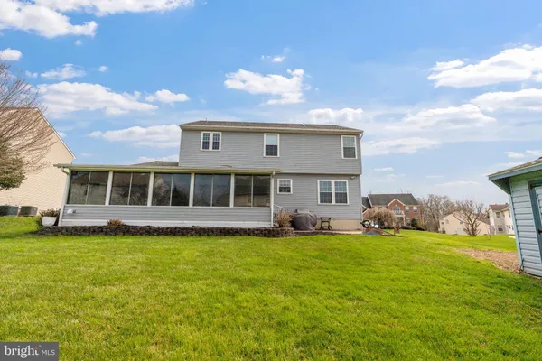 a view of a house with a backyard