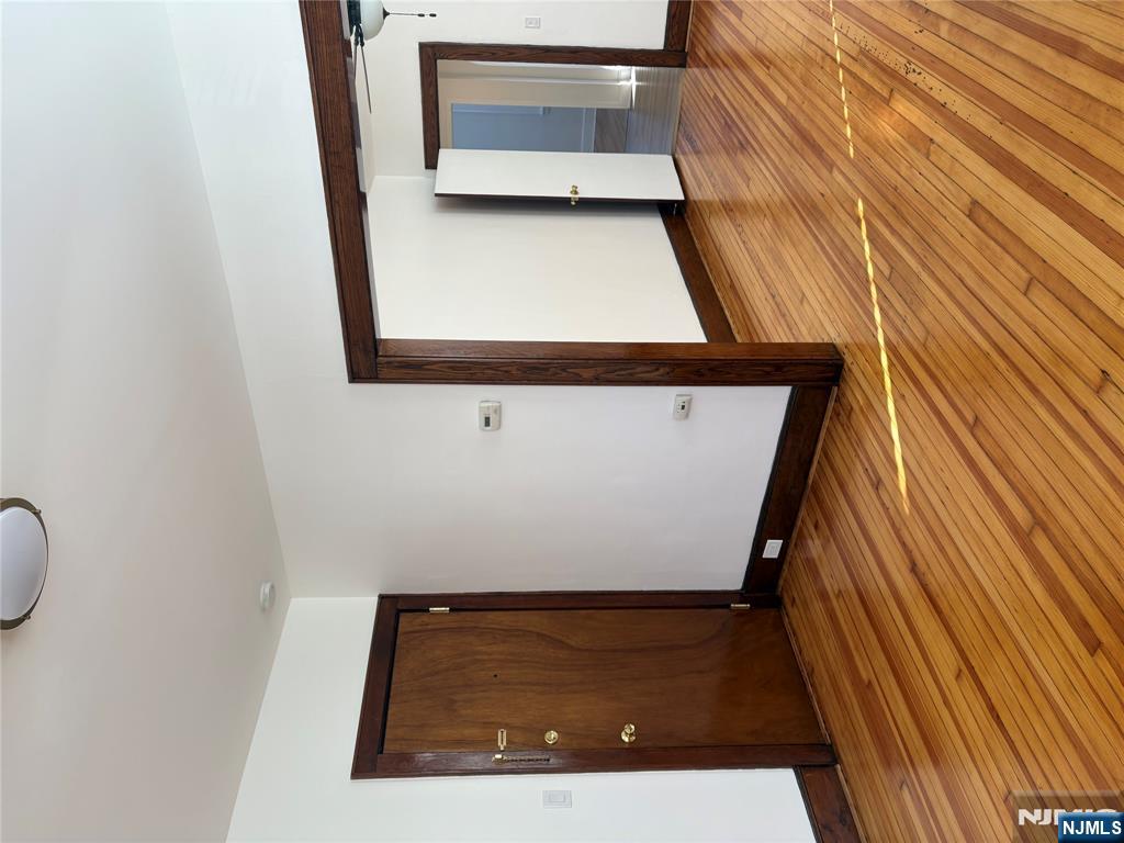 761 Hamilton Street, Unit 2 Harrison, NJ 07029 - Photo 12 of 14 a view of an empty room with wooden floor and closet