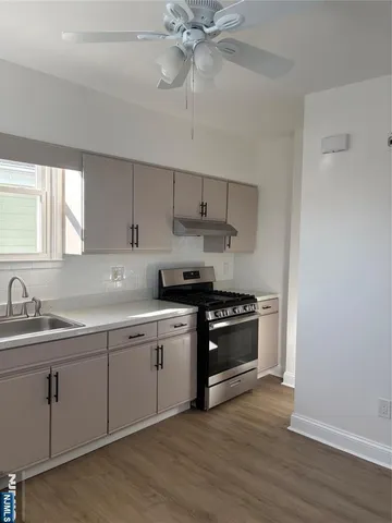 a kitchen with a sink cabinets and stainless steel appliances