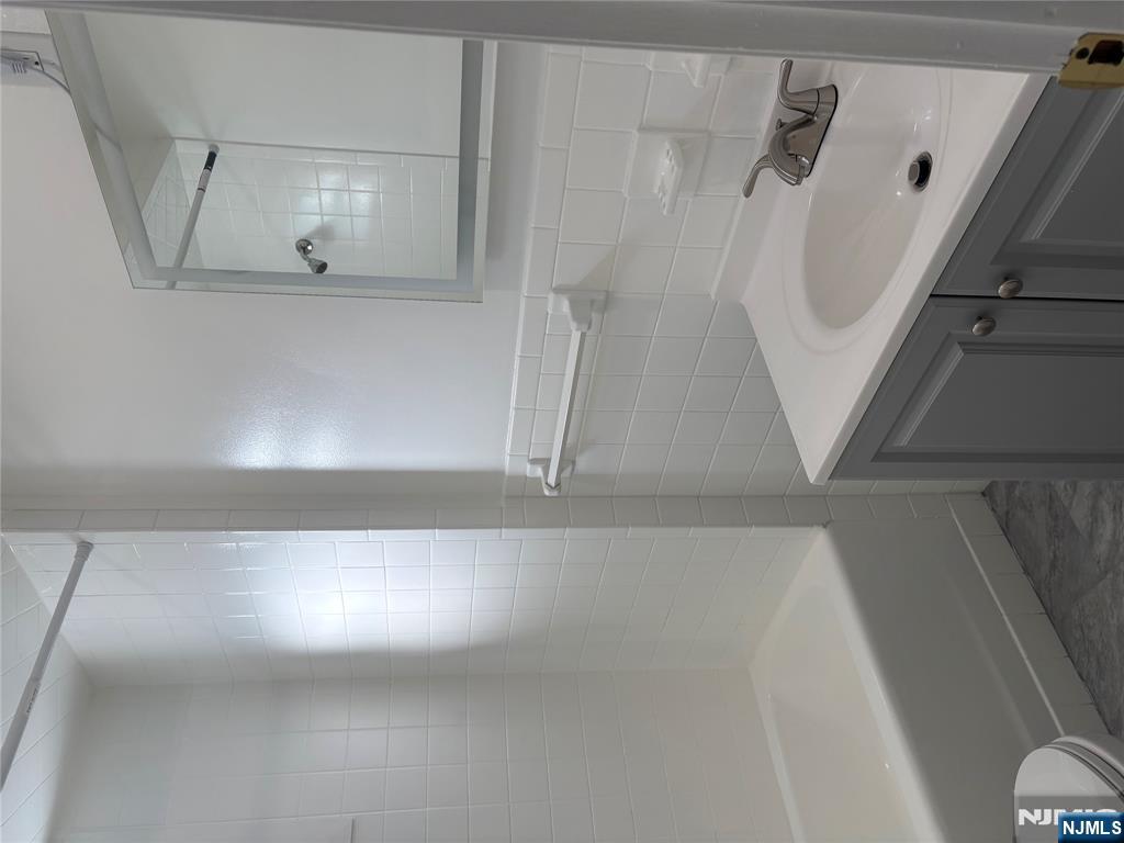 761 Hamilton Street, Unit 2 Harrison, NJ 07029 - Photo 6 of 14 a bathroom with a sink and a bathtub