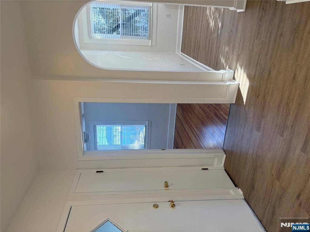 761 Hamilton Street, Unit 2 Harrison, NJ 07029 - Photo 8 of 14 a view of an empty room with wooden floor and a window
