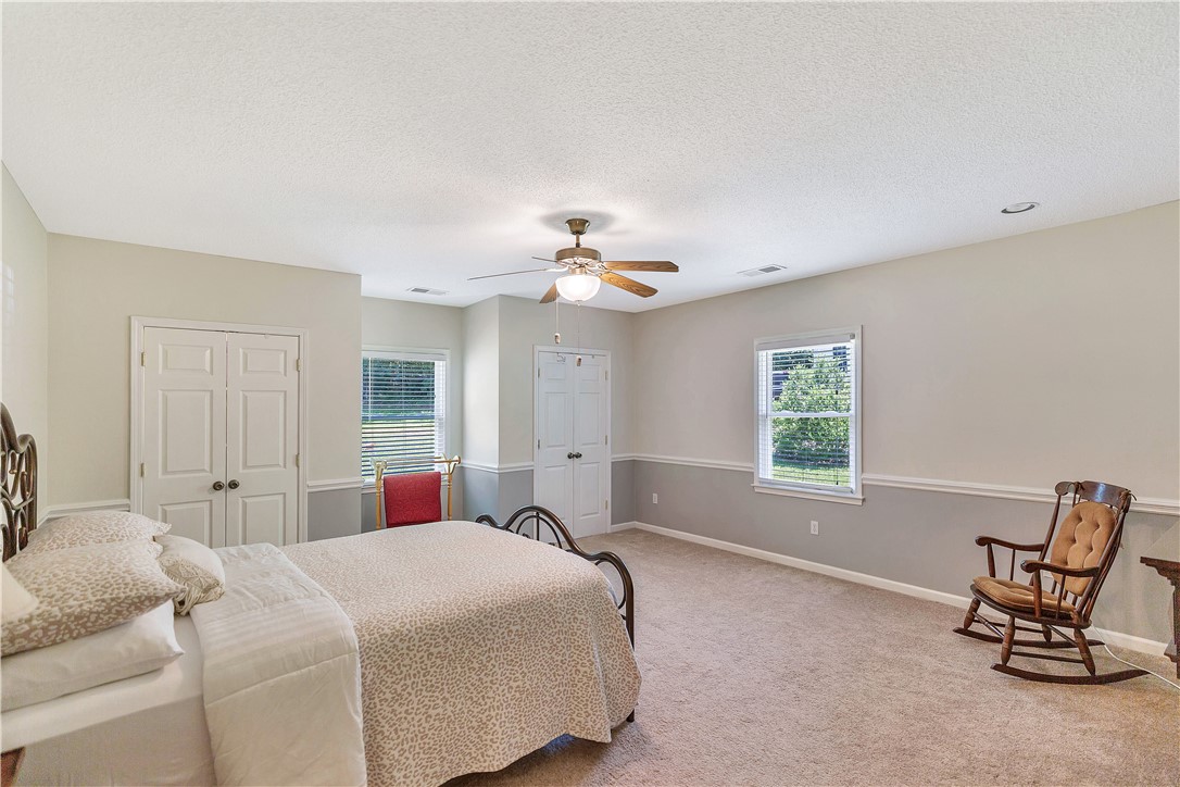 910 Chantilly Lane Anderson, SC 29625 - Photo 13 of 38 A well-proportioned bedroom offers comfort and natural illumination through multiple windows.