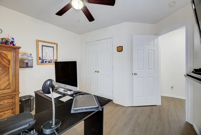 a view of workspace with wooden floor windows
