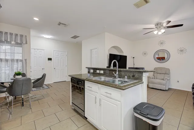 a kitchen with a sink cabinets and window