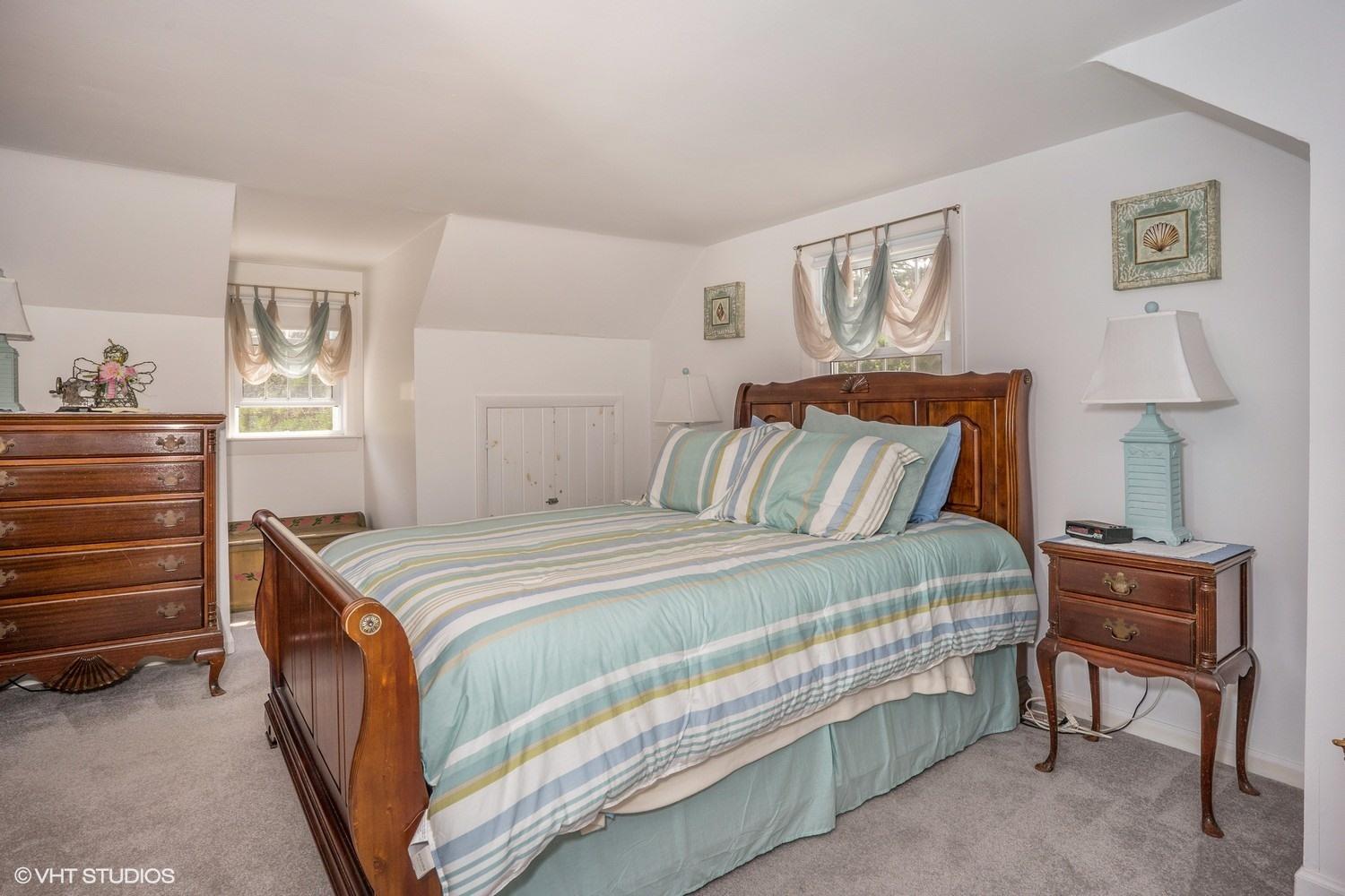 45 Eileen Road Chatham, MA 02633 - Photo 12 of 18 a bedroom with a bed and a lamp on table