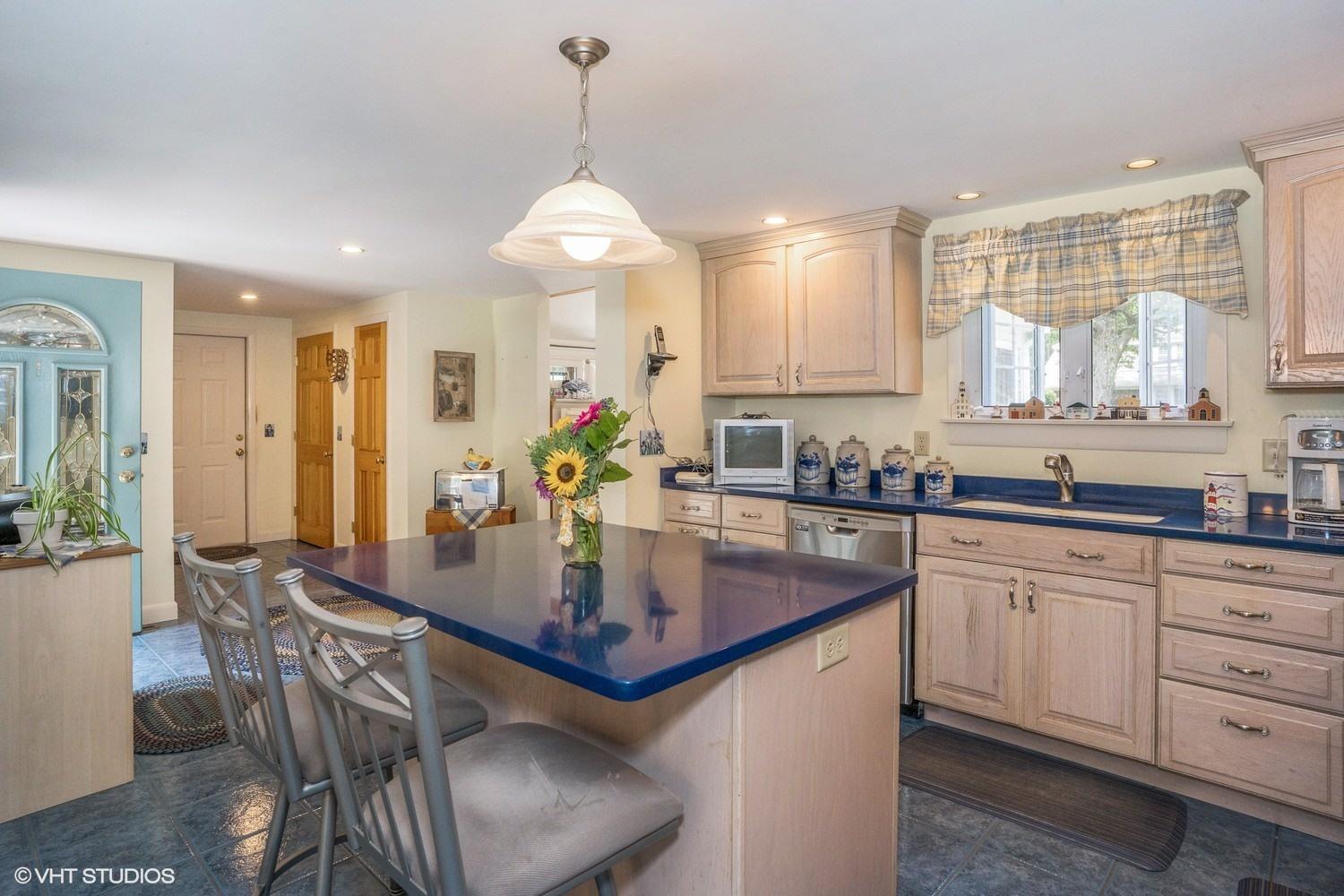 45 Eileen Road Chatham, MA 02633 - Photo 5 of 18 a kitchen with stainless steel appliances granite countertop a dining table chairs and granite counter tops