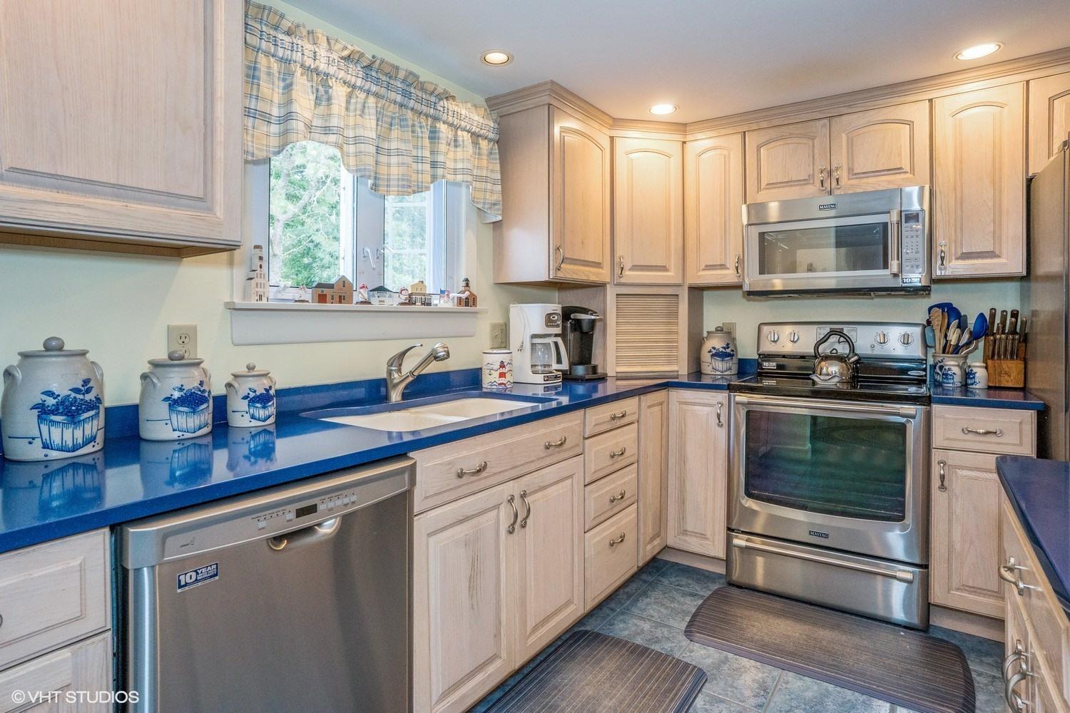 45 Eileen Road Chatham, MA 02633 - Photo 6 of 18 a kitchen with stainless steel appliances granite countertop a stove a sink and a microwave