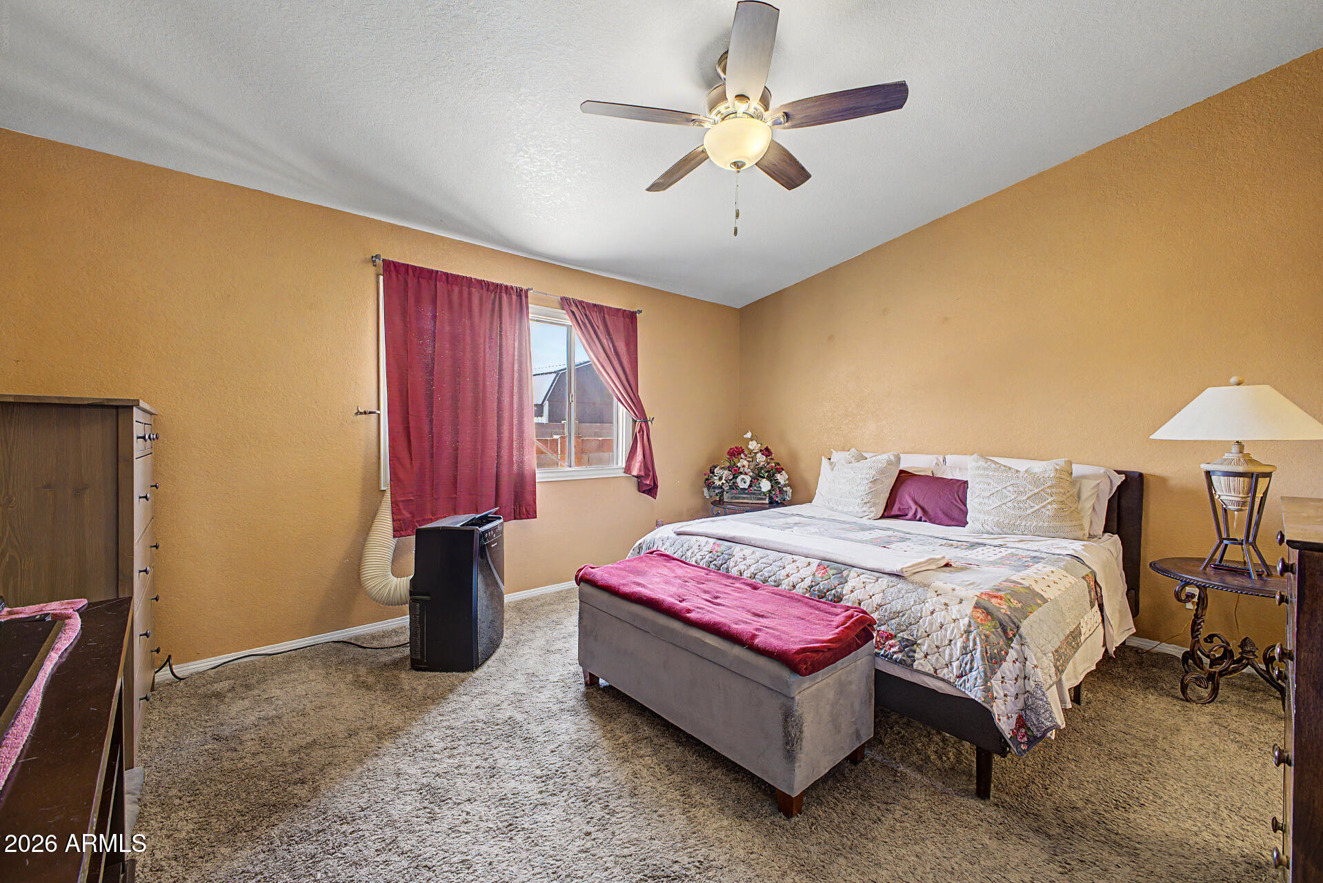 660 South Stardust Lane Apache Junction, AZ 85120 - Photo 8 of 15 a bedroom with a bed chandelier and a window