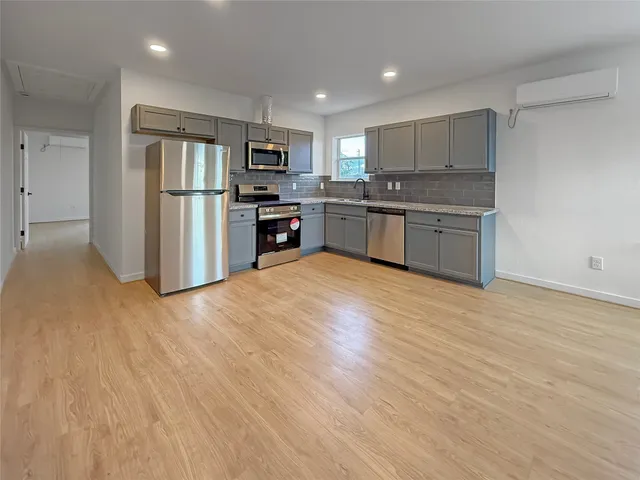 a kitchen with stainless steel appliances granite countertop a refrigerator sink and cabinets